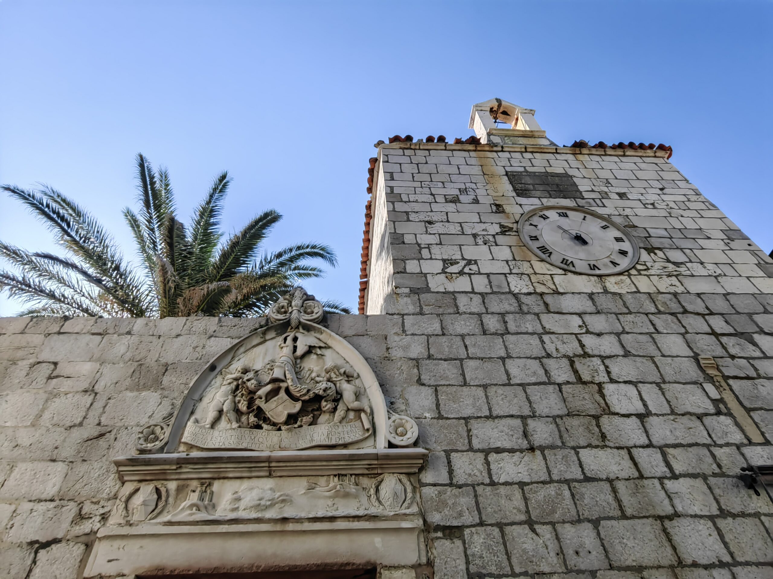 Historic stone tower with a clock in the old town of Pag, Croatia