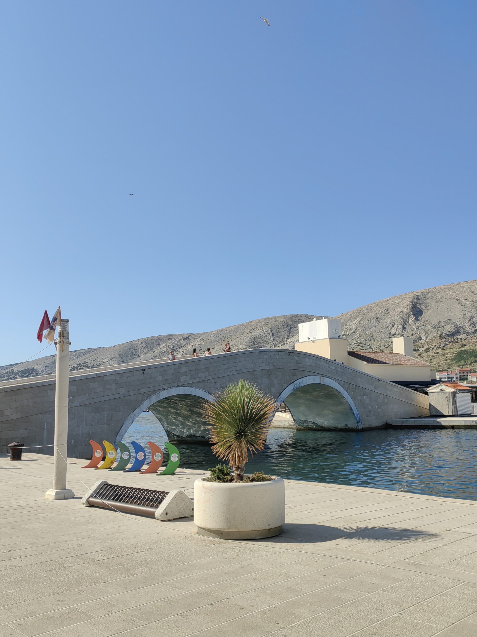 Pag Town Bridge with the waterfront and rocky island landscape in Croatia