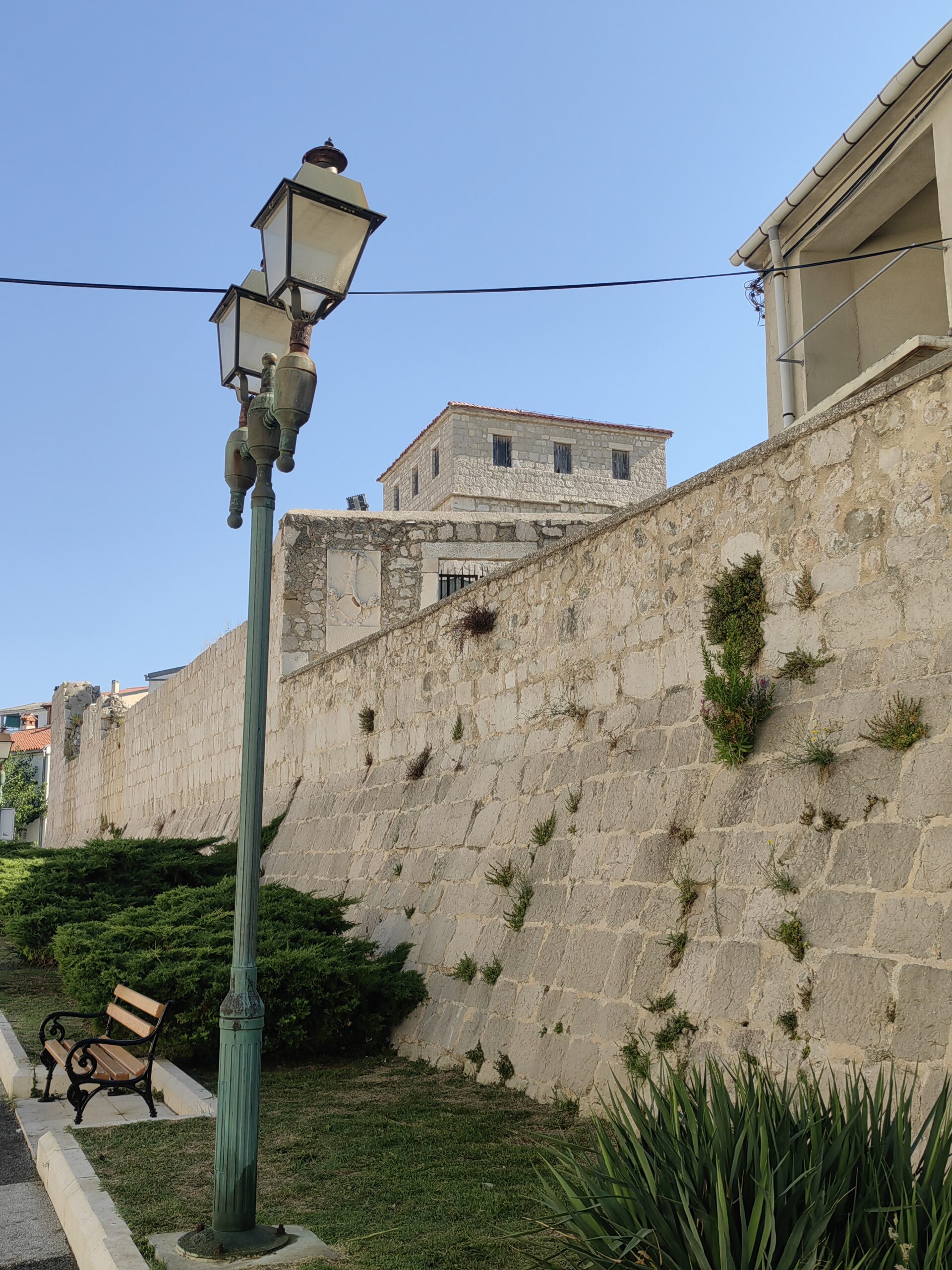Historic stone town walls and Skrivanat Tower in Pag, Croatia
